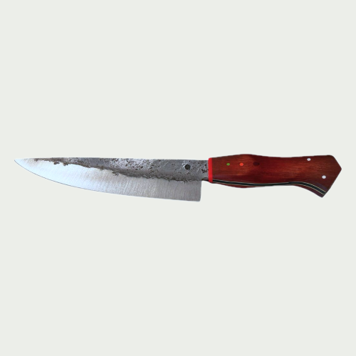 A hand-forged chef's knife with a satin-ground edge, forge finish along the spine and a red hardwood handle with three pins